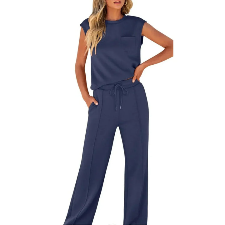 Dark blue casual lounge set with sleeveless top and drawstring pants, studio setting.