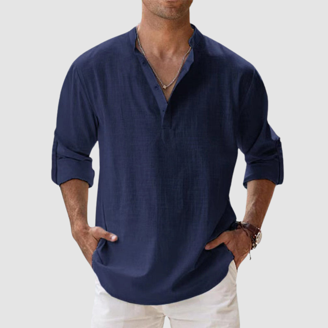 Navy blue long-sleeve breathable shirt with banded collar, button placket, white pants in studio.
