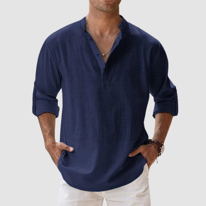 Navy blue long-sleeve breathable shirt with banded collar, button placket, white pants in studio.