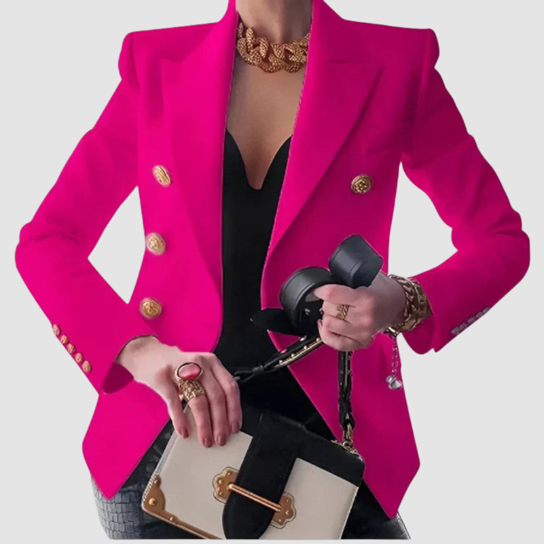 Vibrant pink blazer with gold buttons, worn over a black top. Styled with gold jewelry and a beige handbag in a studio setting.
