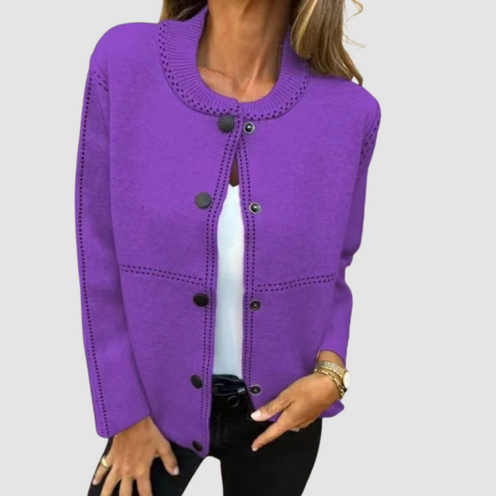 Purple jacket with round collar, button closure, worn over white top and black pants in a studio setting.