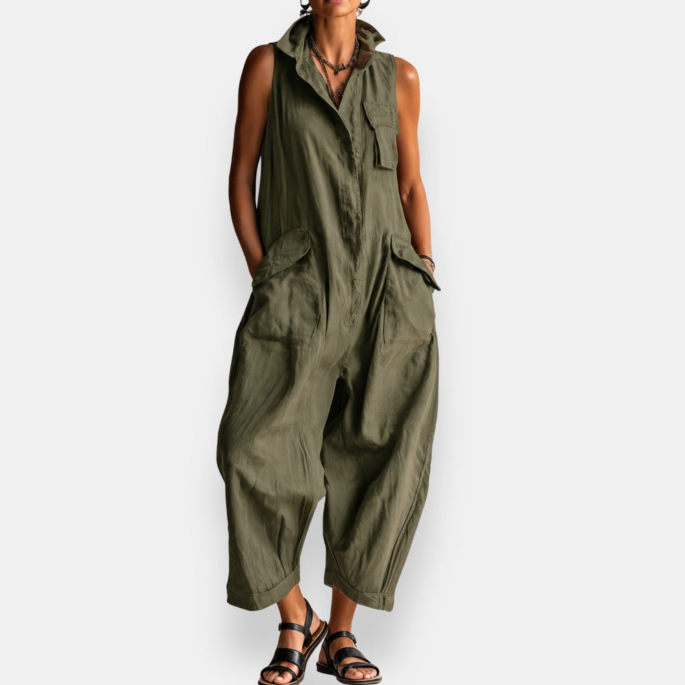 Olive green sleeveless cargo jumpsuit with relaxed fit, button-front design, worn by a model standing, studio background.