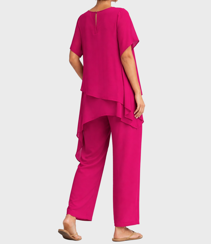 Pink two-piece set with layered tunic, model back view in studio setting.