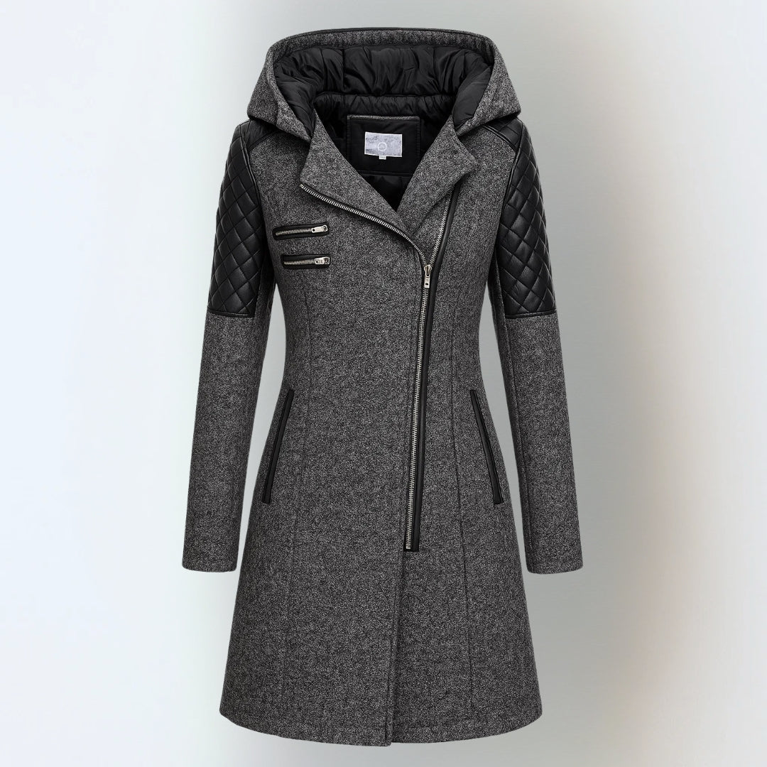 Dark grey hooded winter jacket with black quilted shoulders and asymmetrical zipper, studio background.