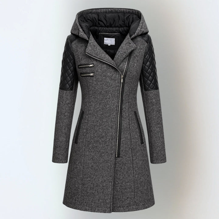 Dark grey hooded winter jacket with black quilted shoulders and asymmetrical zipper, studio background.