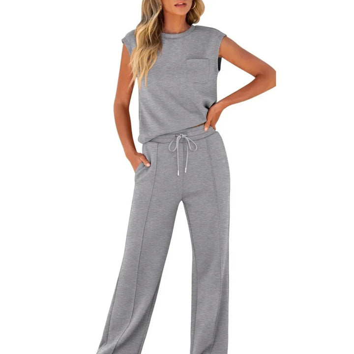 Gray casual lounge set with sleeveless top and drawstring pants, studio setting.