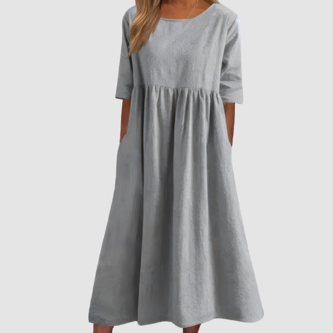 Light gray breezy dress with elbow-length sleeves in a studio setting.