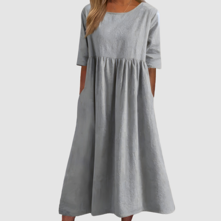 Light gray breezy dress with elbow-length sleeves in a studio setting.