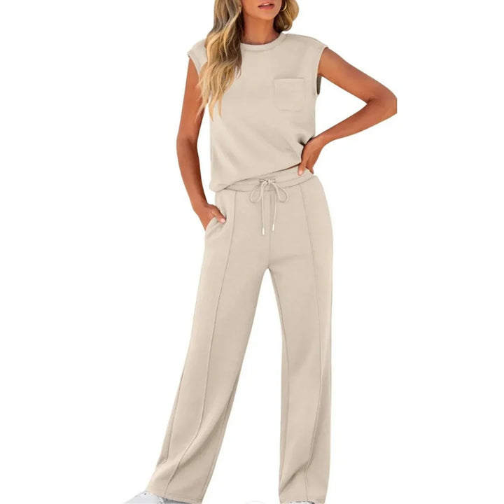 Beige casual lounge set featuring sleeveless top and drawstring pants, studio setting.