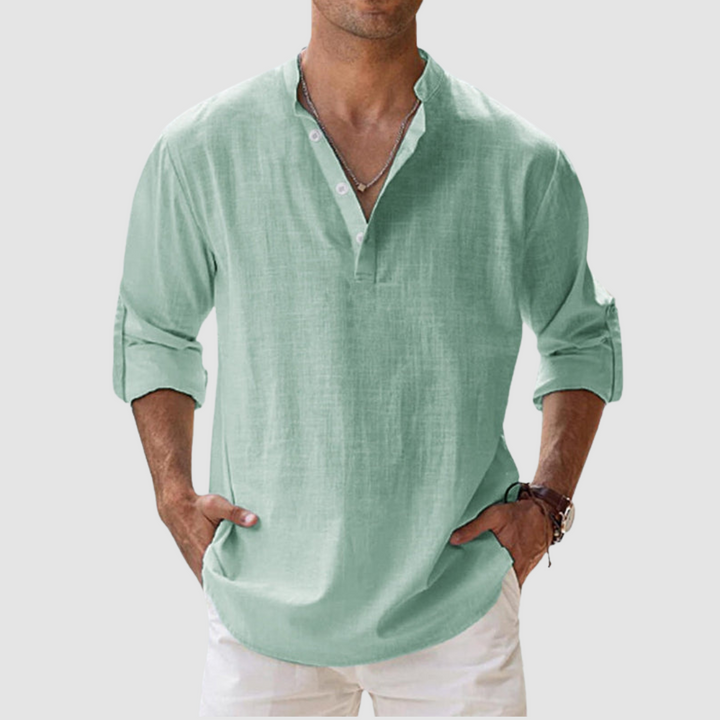 Mint green long-sleeve breathable shirt with banded collar, button placket, white pants in studio.