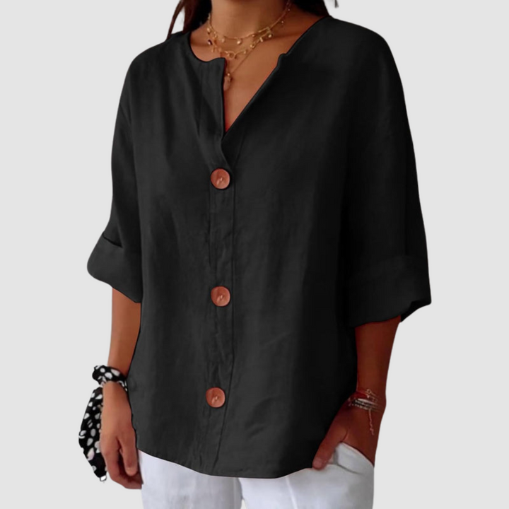 Black casual blouse, simple design with button details, on a white background.