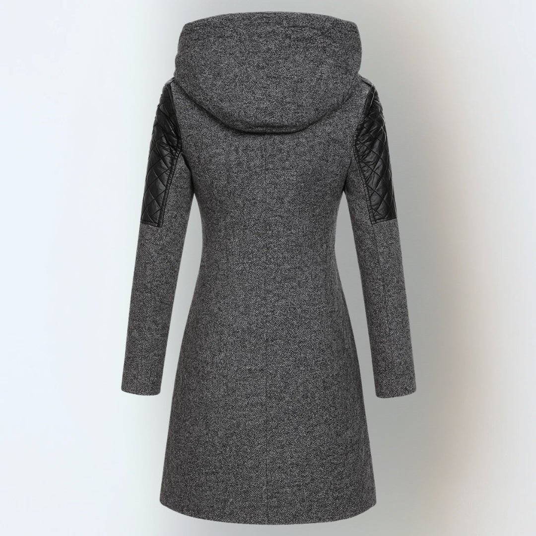 Back view of dark grey hooded winter jacket with black quilted shoulders, studio background.