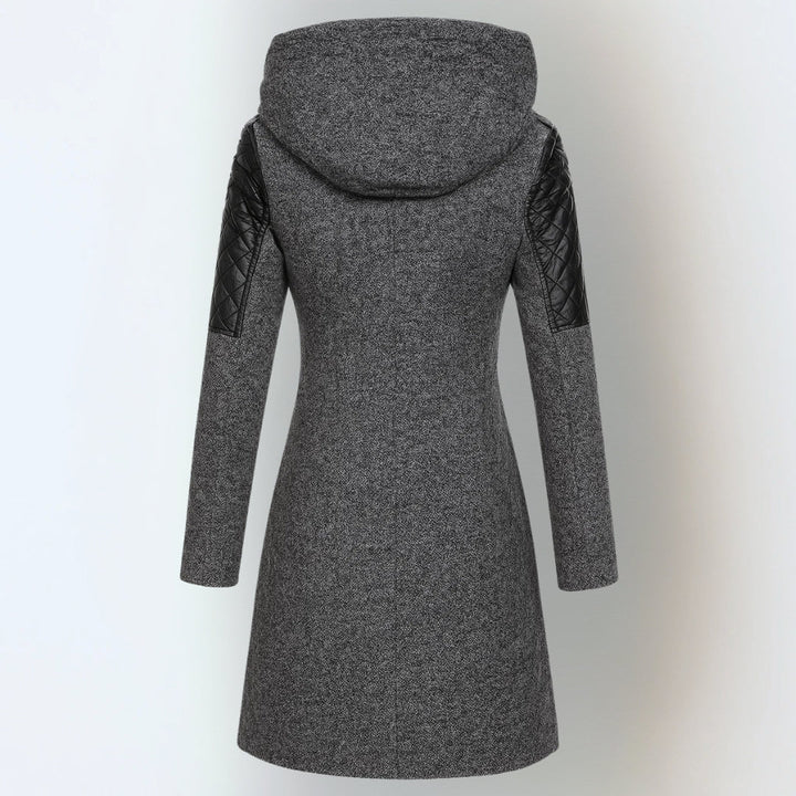 Back view of dark grey hooded winter jacket with black quilted shoulders, studio background.