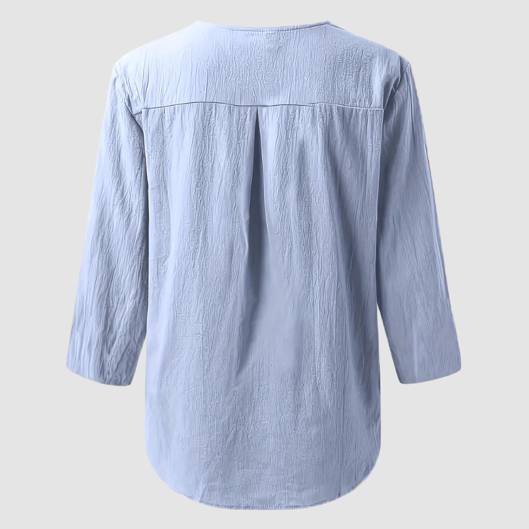 Back view of a light blue casual blouse displayed flat against a plain background.