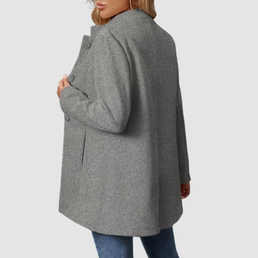 Back view of gray jacket with large buttons, worn over jeans, against a plain background.
