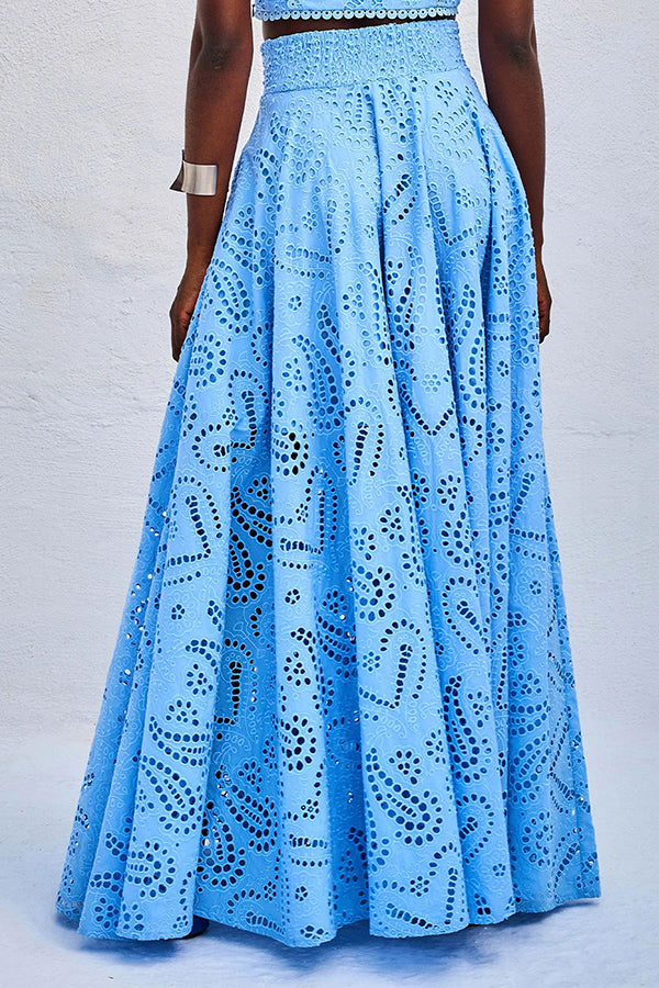 Back view of blue embroidered high-waist maxi skirt worn by a model against a plain white backdrop.