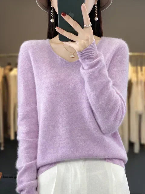 Person wearing a soft lilac loose knit sweater in a fashion studio setting.