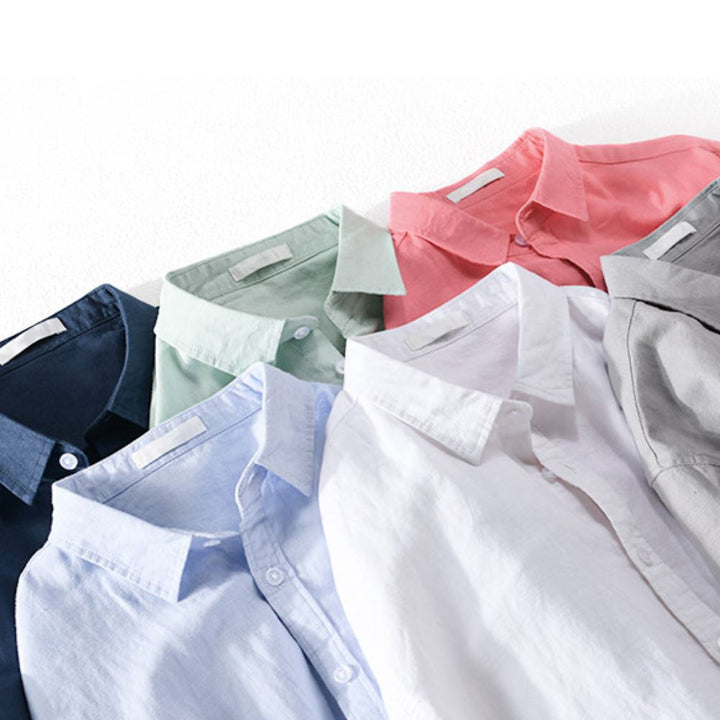 Close-up of shirts in assorted colors laid out overlapping.
