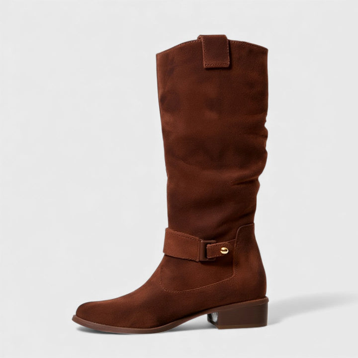 Single reddish-brown knee-high boot with buckle detail and heel, studio background.