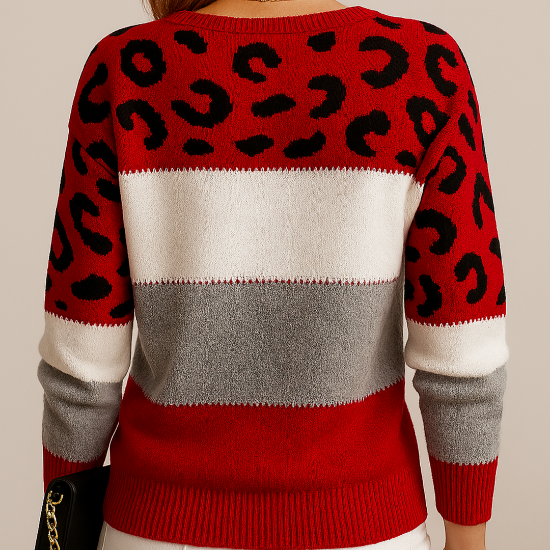 Back view of fashionable red jumper with leopard print and striped design on model in studio.