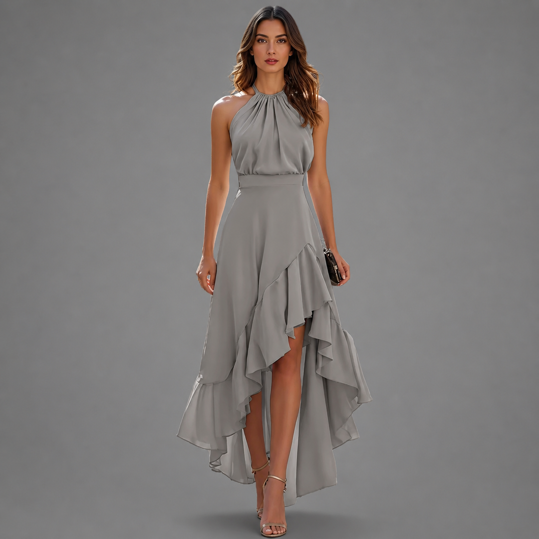 Stylish gray maxi dress with a halter neck and layered ruffled hem, set against a gray studio background.