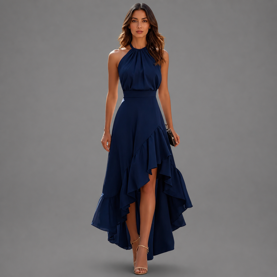 Chic navy blue maxi dress featuring a halter neck and flowing ruffled hem, displayed in a gray studio setting.