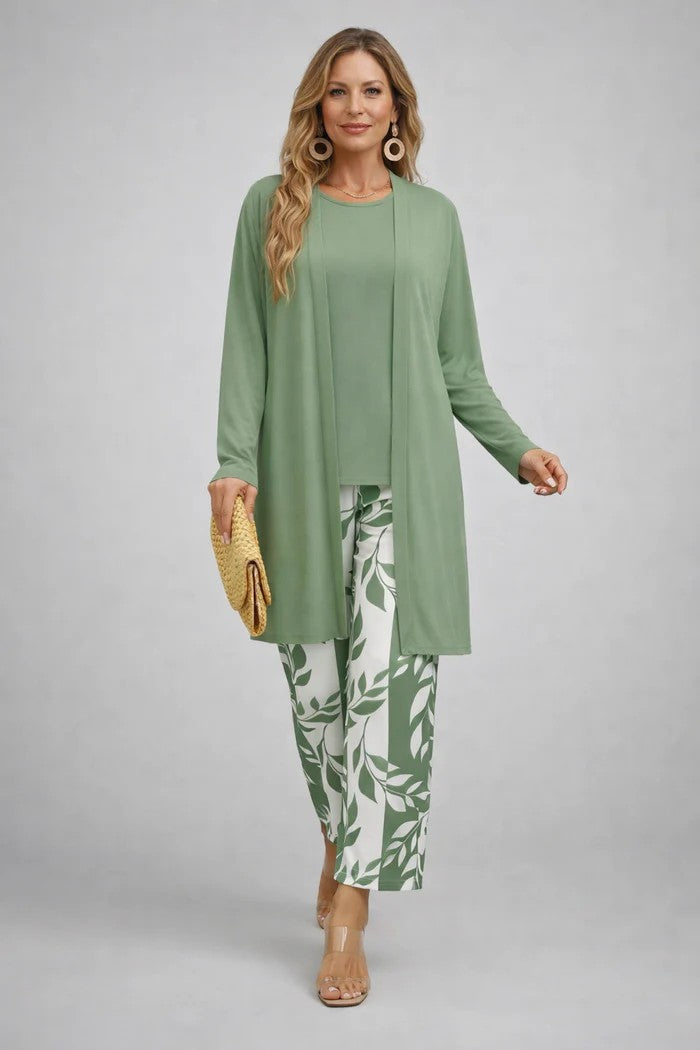 Woman in a mint green three-piece set with white patterned pants. Grey studio setting.