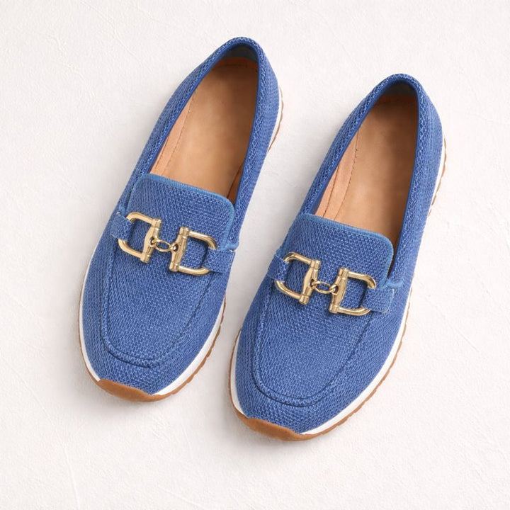 Pair of blue orthopedic loafers with gold accents on a white background.