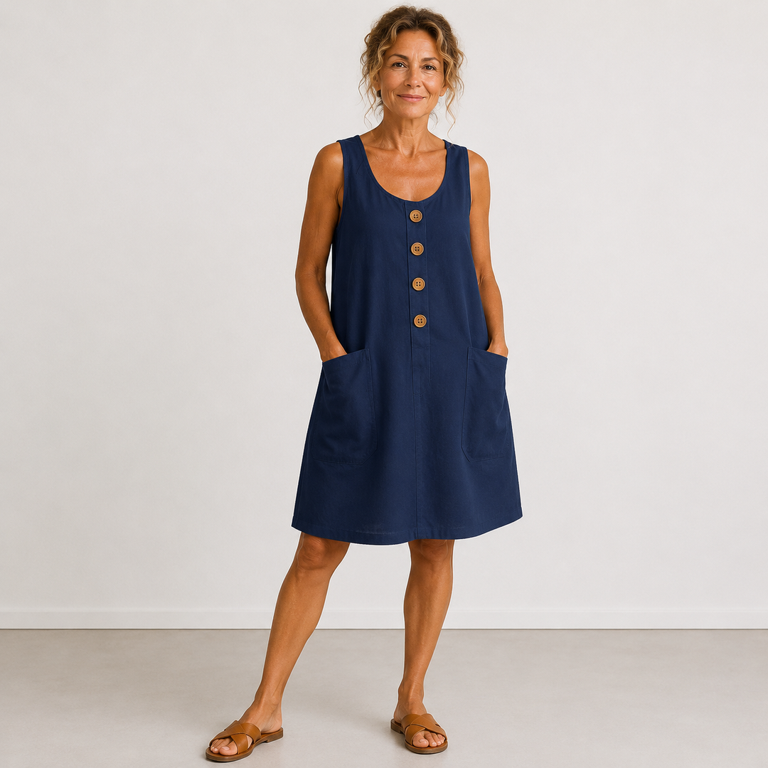 Navy blue summer dress with buttons and pockets, worn in a studio setting.
