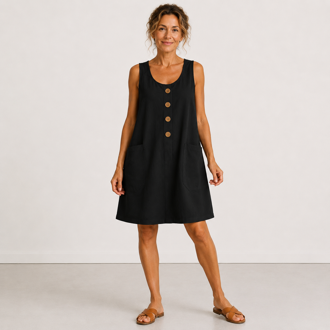 Black summer dress with buttons and pockets, worn in a studio setting.