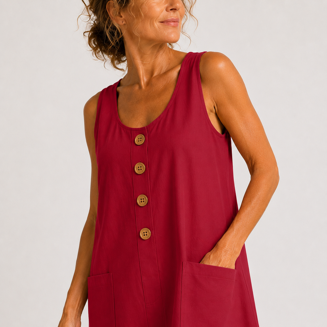 Close-up of a red dress with buttons and pocket, worn in a studio setting.