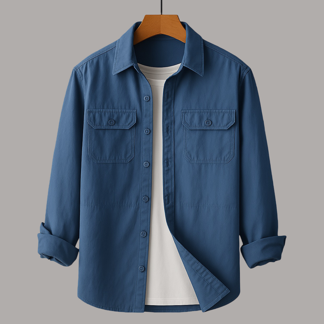 Deep blue shirt with chest pockets over a white tee on wooden hanger, gray studio background.