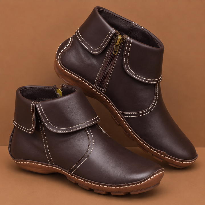 Brown orthopedic waterproof boots with side zippers shown on a brown background.