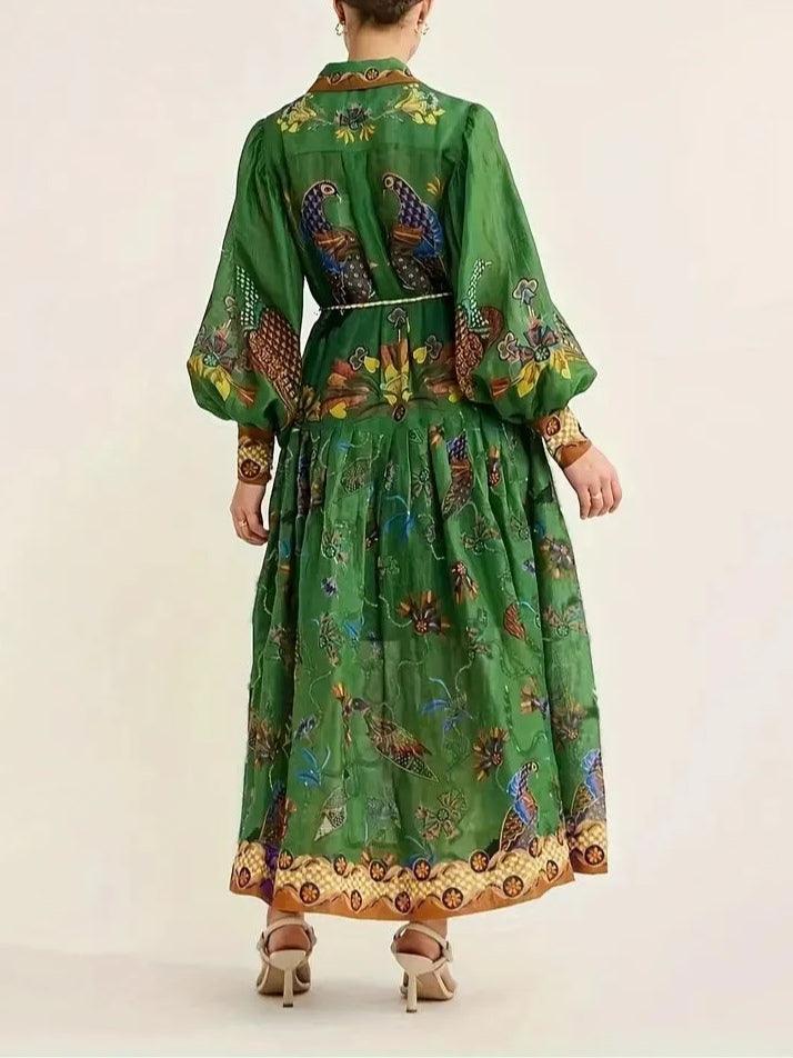 Back view of green floral print maxi dress with puff sleeves, studio shot.
