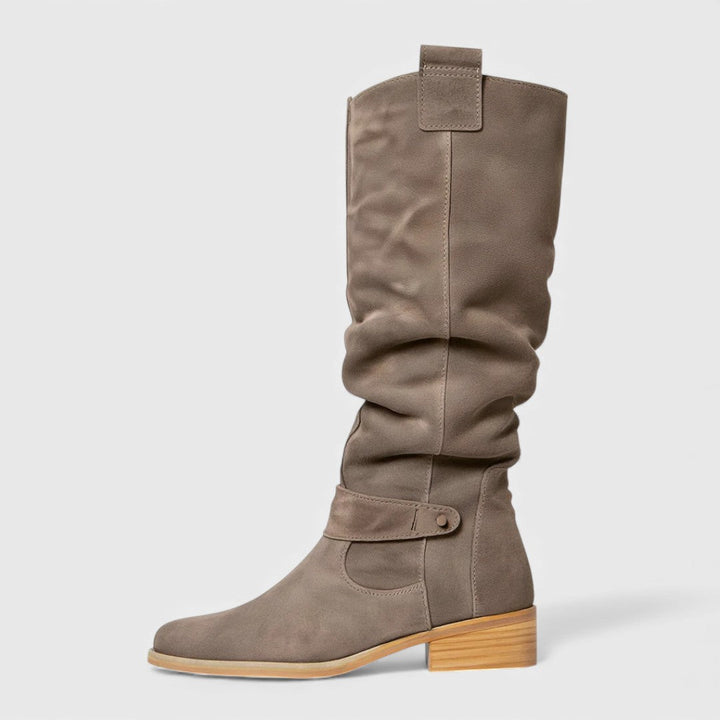Single gray knee-high boot with buckle detail on a wooden heel, studio background.
