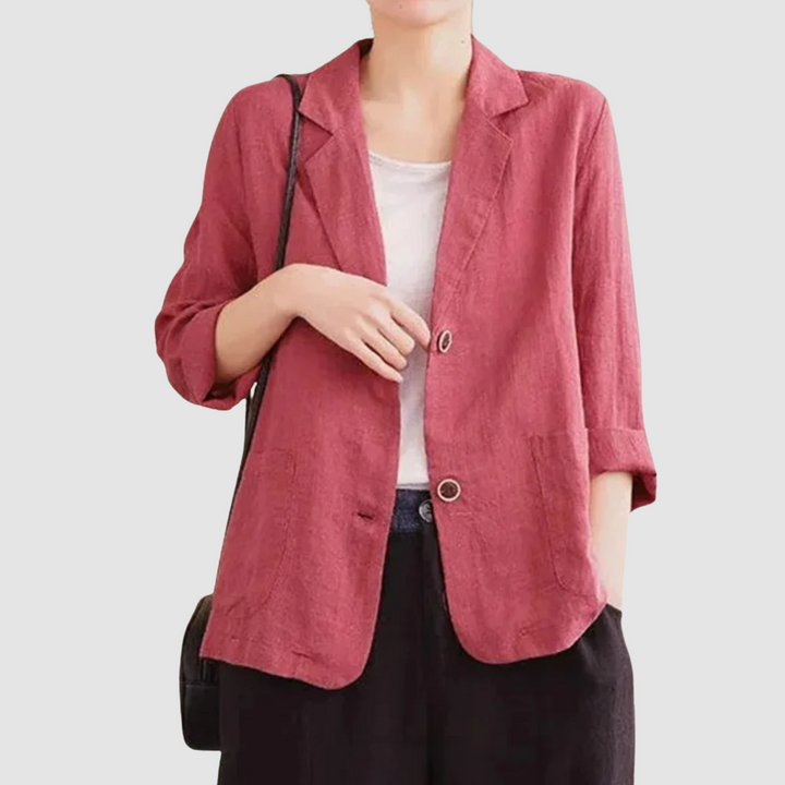 Casual chic red blazer with rolled sleeves and front pockets paired with a white top and black pants, on a light gray background.