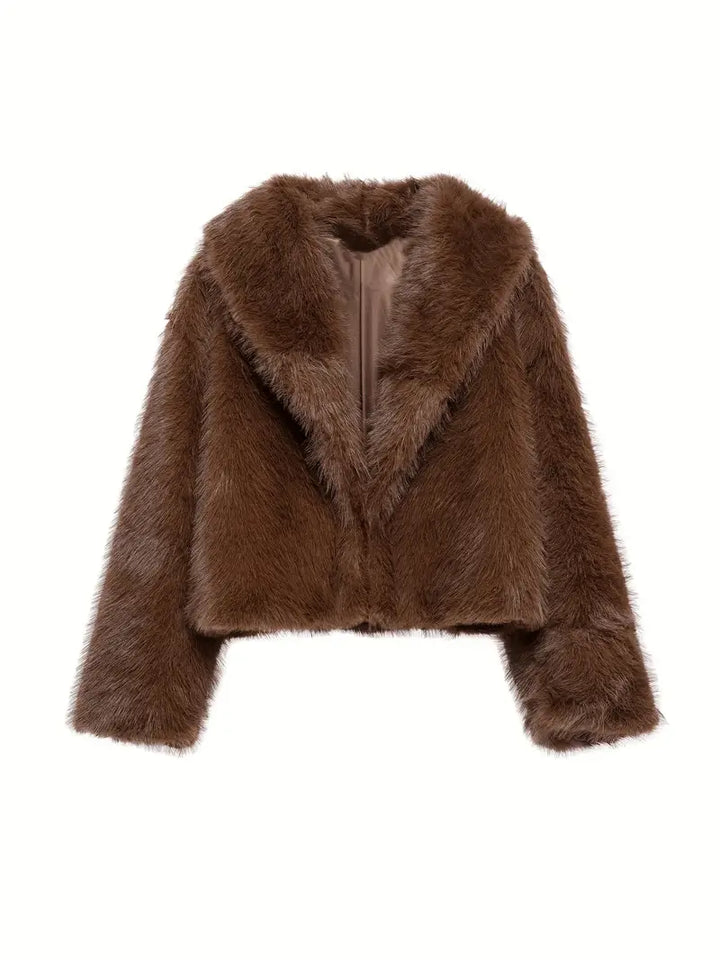 Brown fur jacket displayed against a white background, showcasing its soft texture and elegant design.