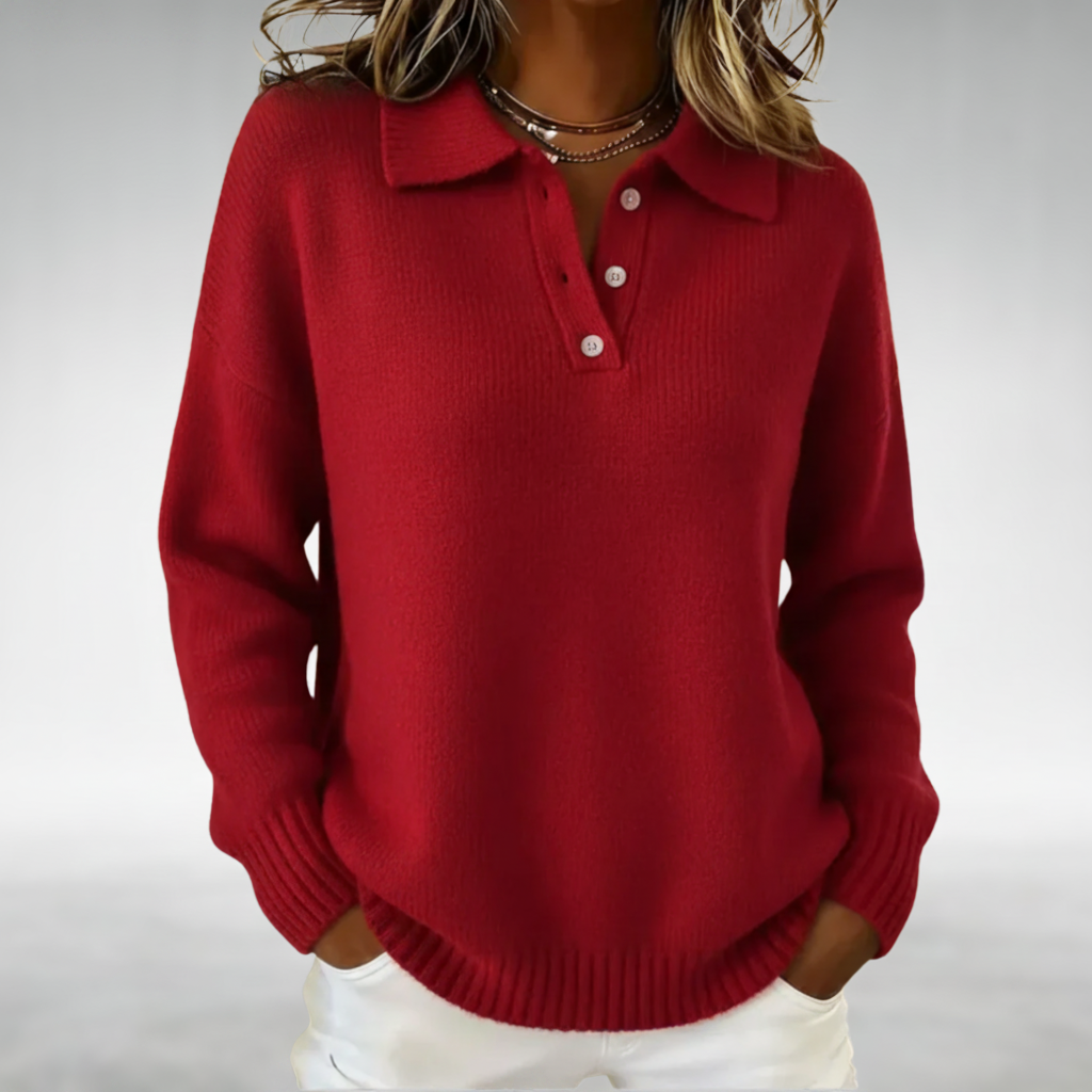 Red cozy jumper with a buttoned collar, worn with white pants in a studio setting.