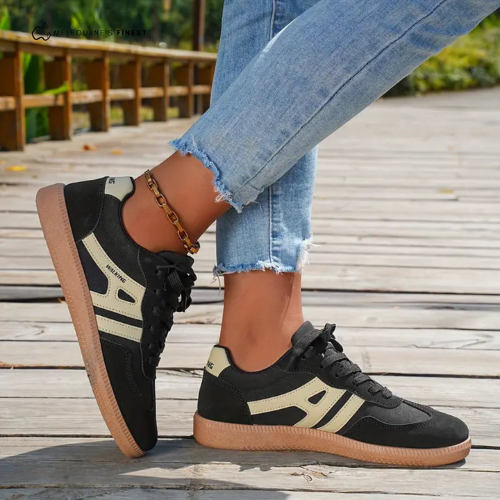 Black and beige orthopedic shoes on a woman&