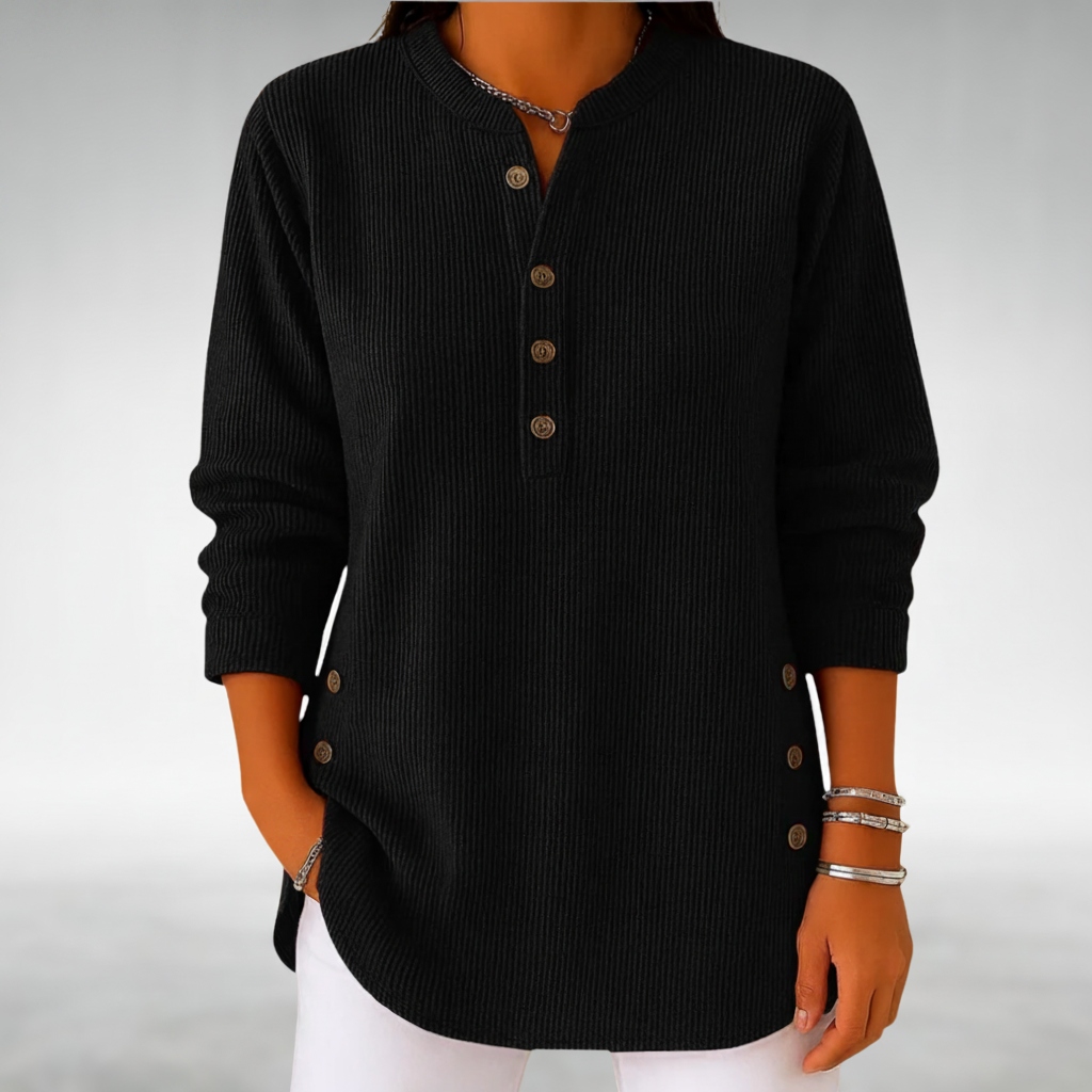 Black jumper with buttons in a simple studio environment.