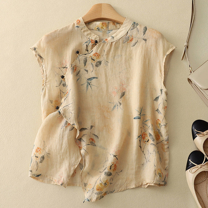Beige floral sleeveless top on a hanger, with soft texture, set against a light background with shoes and a bag.