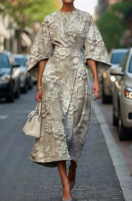 Elegant gray dress with floral embroidery, kimono sleeves, belted waist, worn outdoors on a city street.