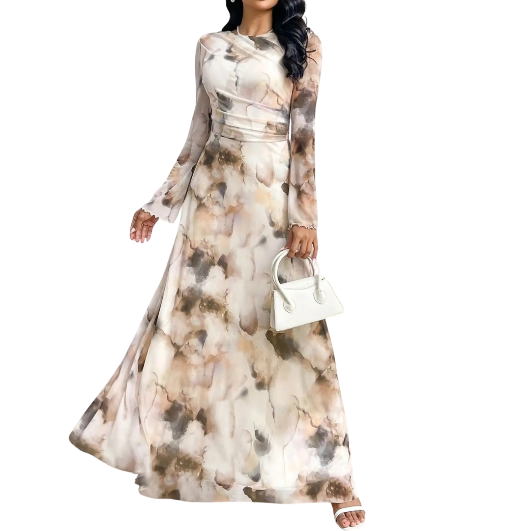 Elegant long dress in a flowing, abstract watercolor pattern, long sleeves, paired with a white handbag, studio backdrop.