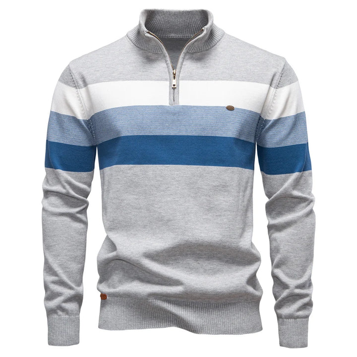 Gray and blue striped pullover displayed on a plain white studio background.
