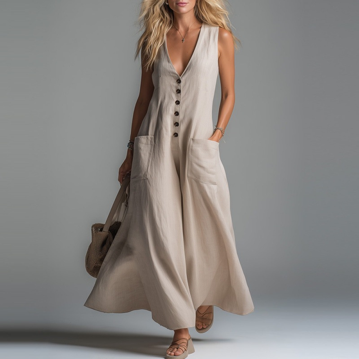 Beige maxi dress with buttons and pockets, worn by a model in a studio setting.