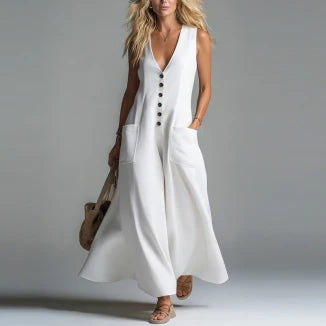 White maxi dress with buttons and pockets, worn by a model in a studio setting.