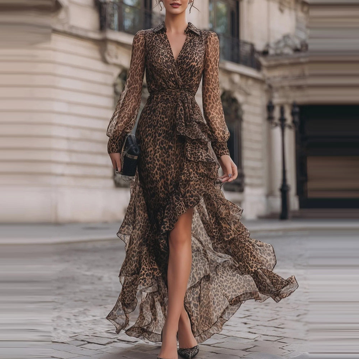 Leopard print lace maxi dress with long sleeves and ruffled hem, worn by a model walking on an urban cobblestone street.