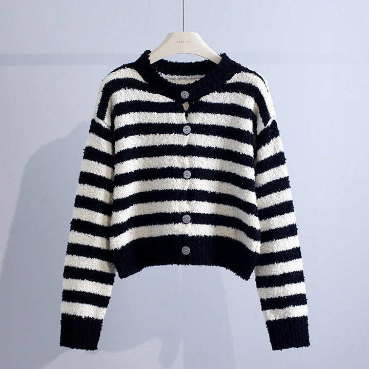 Black and white striped cardigan with buttons, set against a light gray studio backdrop.