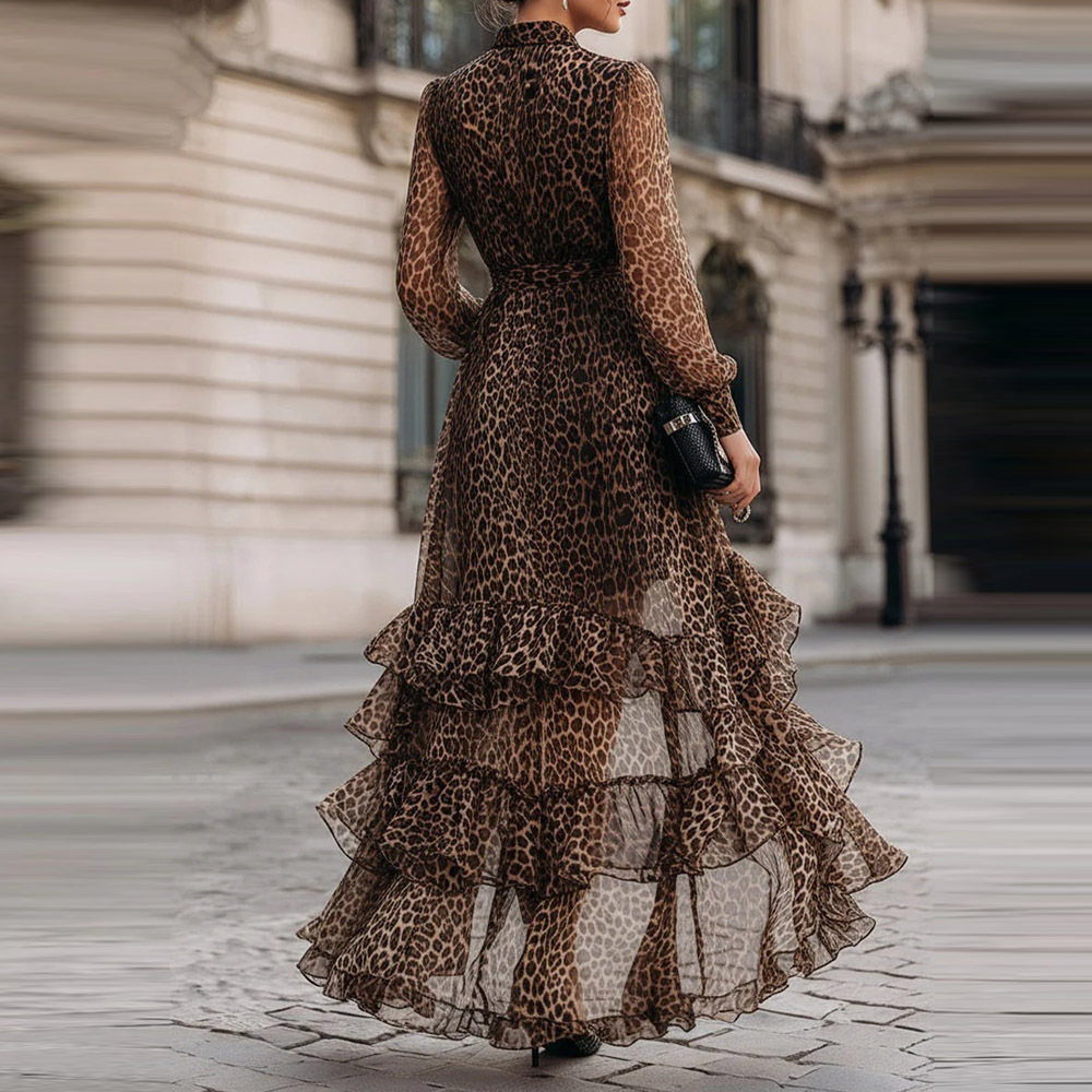 Back view of a leopard print lace maxi dress with tiered ruffles, worn by a model on a city street.