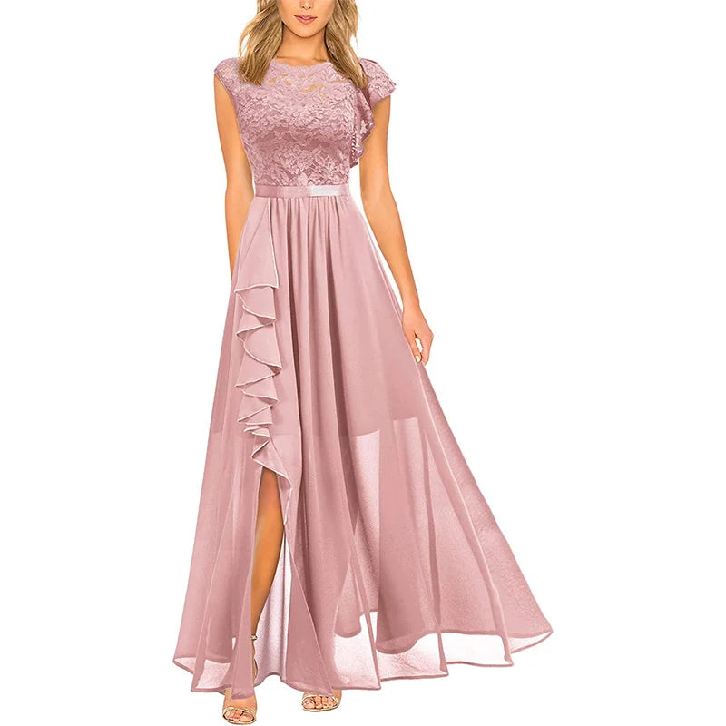 Elegant pink dress with lace bodice and flowing skirt, featuring a ruffled slit, displayed on a model in studio setting.